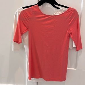 2 T shirts! White + Coral color. Scoops in the back!